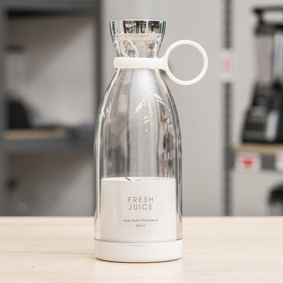 Clear bottle with white label on a counter in a store setting